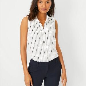 Ann Taylor black and white sleeveless button front blouse.